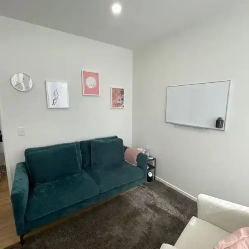 Cozy living room featuring a couch, a chair, and a television, perfect for relaxation and entertainment.